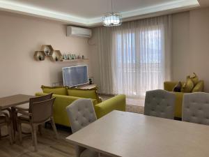 a living room with a couch and a table and chairs at Vlora Center Veranda in Vlorë