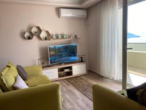 a living room with a couch and a television at Vlora Center Veranda in Vlorë