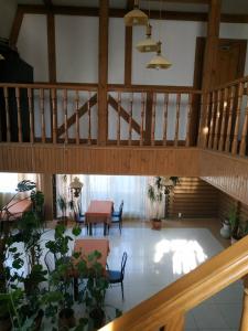 a room with a staircase and a table and some plants at Hotel Restaurant Complex Boyarskiy Dvor in Boyarka