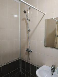 a bathroom with a shower with a sink and a mirror at Hotel Restaurant Complex Boyarskiy Dvor in Boyarka