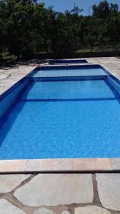 a large blue swimming pool sitting on a sidewalk at Estância Morro Do Frota in Pirenópolis