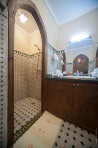 a bathroom with a shower and a sink at Riad Bab Tilila in Marrakech