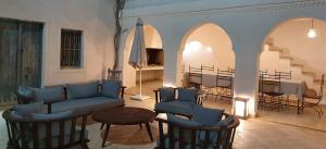 a living room with a couch and chairs and a table at Dar Ennour Djerbahood Erriadh in Houmt Souk