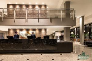 a kitchen with a large counter top and a large window at Bourbon Dom Ricardo Aeroporto Curitiba Business Hotel in São José dos Pinhais