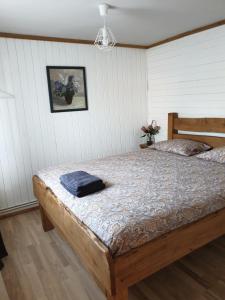 a bedroom with a bed with a blue towel on it at Vacation House Terraces in Sigulda