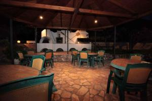 a group of tables and chairs in a restaurant at Almini Apartments in Plataria