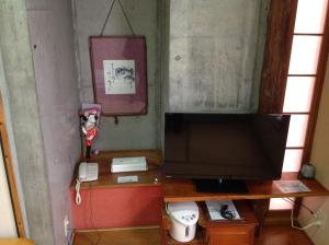 a living room with a television and a telephone at Asano Hotel in Kitakyushu