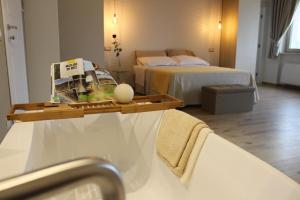 a hotel room with two beds and a bath tub at LE CANONICHE NEL MATESE ALBERGO DIFFUSO in San Massimo