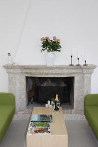 a living room with a fireplace and a coffee table at LE CANONICHE NEL MATESE ALBERGO DIFFUSO in San Massimo