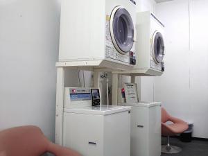 a room with two washing machines on a shelf at Ueno Frex Hotel in Iga