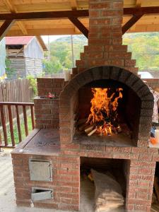 a brick oven with a fire inside of it at Vila Chiojdu in Buzau