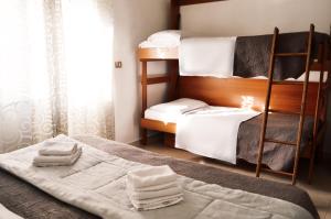 מיטה או מיטות בחדר ב-Hotel Colombo