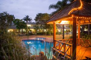 a resort pool with a gazebo at night at Country Motel Ipswich in Ipswich