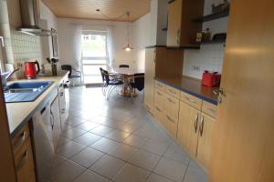a kitchen with a sink and a counter top at Ferienwohnung Römerweinhof in Neumagen-Dhron +3 photos