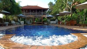 a swimming pool with a fountain in the middle at TARA LODGE Haven of peace in Kep