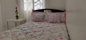 a bed with pink and white sheets and pillows at Julzhome PH Properties by Juliet AfricaPervaze in Santa Rosa