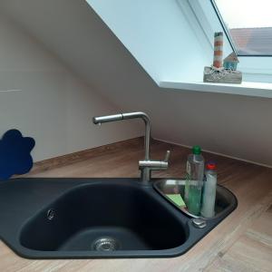 a sink in a kitchen with a window at Nordstern in Tönning