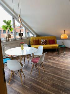 a living room with a couch and a table and chairs at Sonnige Wohnung im Herzen von Marbach in Marbach am Neckar