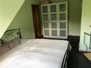 a bedroom with a bed and a large closet at Ferienwohnung im Grünen auf idyllisch gelegenen Gutshof und doch so zentral in Waldshut-Tiengen