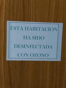 a sign on a wooden door that reads esa halibration hsa sub at Motel Acropolis in Camponaraya