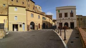an empty street in a town with buildings at Lucas House in Bibbona