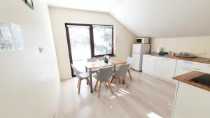 a kitchen and dining room with a table and chairs at K-Town - Apartment near the Lake in Kaunas