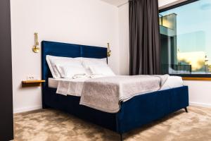 a blue bed in a room with a window at Olive Tree mansion in Vir +83 photos
