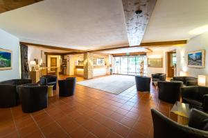 a large room with chairs and a lobby at Parkhotel Sonnenhof in Oberammergau