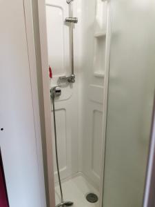 a shower in a bathroom with a glass door at Appartement duplex in Le Boulou