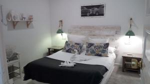 Łóżko lub łóżka w pokoju w obiekcie Hostal Vidamia