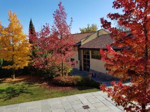 a house with autumn trees in front of it at Certosa 1515 in Avigliana