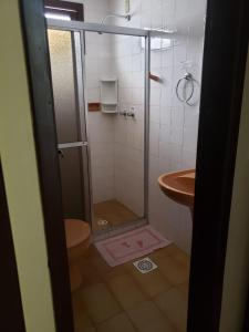 a bathroom with a shower and a sink at Hotel Mar Navegantes in Pinhal