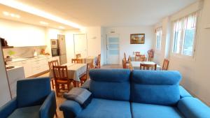 a living room with a blue couch and a kitchen at Balentziaga in Azcoitia