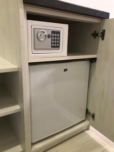 a microwave on a shelf in a closet at Holiday house in Vinnytsya