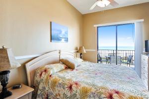 a bedroom with a bed and a view of the ocean at Phoenix 5 Unit 116 in Orange Beach +41 photos