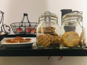 a shelf with jars of food and a plate of bread at House Petit Lusa in Lisbon