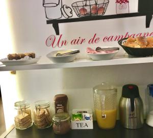 a kitchen shelf with food and items on it at House Petit Lusa in Lisbon