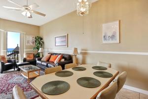 a living room with a table and a couch at Phoenix 5 Unit 116 in Orange Beach