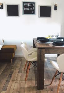 een eetkamer met een houten tafel en witte stoelen bij Apartment Gabi 2 in Umag