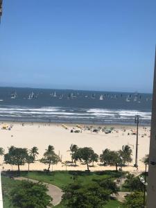 a view of a beach with people and the ocean at Apto Gonzaga Frente ao Mar Wi-Fi in Santos