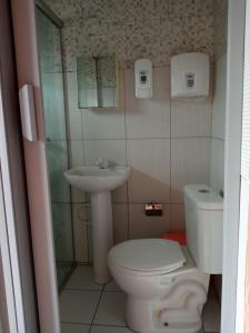 a bathroom with a toilet and a sink at Pousada da Lurdinha in Lençóis +28 photos