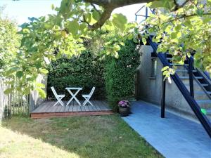 德哈恩't Valkennestje的木甲板上摆放着两把白色椅子