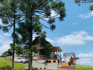 una casa en construcción en un campo con un árbol en Morada nas Montanhas Chale 08, en Urubici