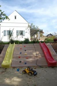 a playground with a slide and a play equipment at Patakporta in Ábrahámhegy