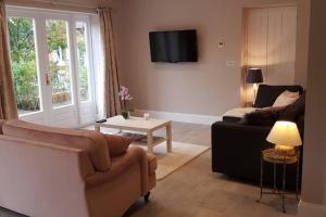 a living room with a couch and a table at Kiln Cottage in Fareham
