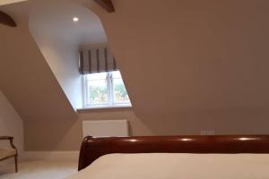 a bedroom with a bed and a window at Kiln Cottage in Fareham