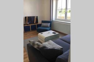 a living room with a couch and a table at HAUS mit 3 Schlafzimmer und Garten in Amstetten