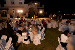 a group of people sitting in chairs at a wedding at ilyda Residence apts in Skala Kallonis +56 photos