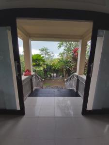 an open door of a building with a hallway at Villa Gede Private Guest House in Selemadeg