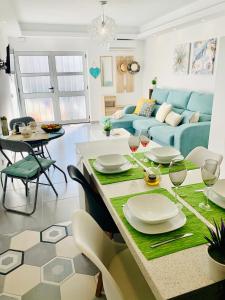 a living room with a table and a blue couch at COSY MODERN HOUSE - CENTER ALBUFEIRA - OLD TOWN in Albufeira